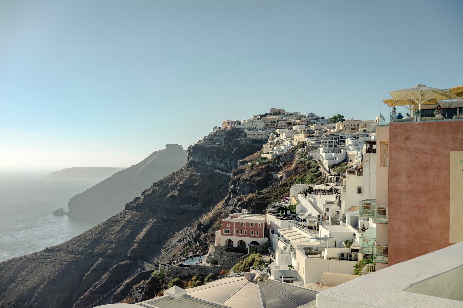 The whitewashed buildings of Fira stepping down the caldera cliffs of Santorini toward the sea